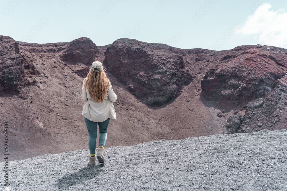 Woman hiking on Mount Etna. It's a active vulcano in Sicily.