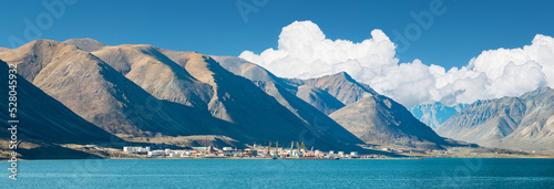 Mountain range, sky with clouds and Egvekinot village in Chukotka. photo