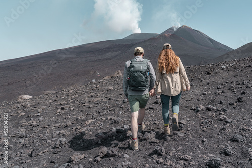 Couple hiking to a vulcanom the mount Etna. photo