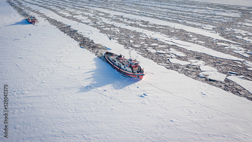 Icebreakers on river in win...