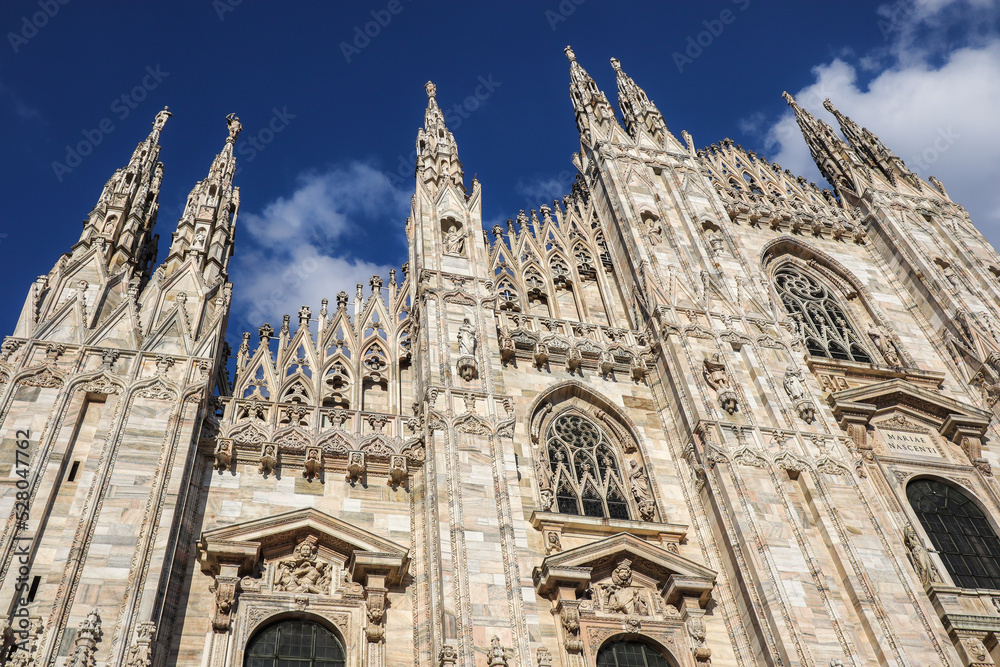 Duomo di Milano in Lombardy. Beautiful Gothic Architecture in Milan with Blue Sky. Exterior of Italian Monument.
