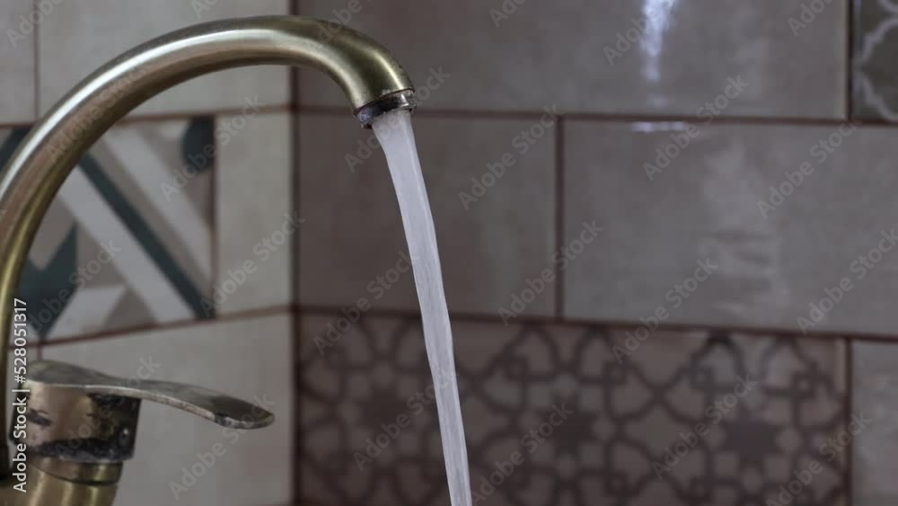 The Water Faucet In A Kitchen. Jet Water Tap Stream Pours. Vintage Bronze Faucet Water. Water Tap In Kitchen. Dolly Slider Shot. 60 FPS, 4k, ProRes The Water Faucet In A Kitchen. Jet Water Tap Stream Pours. Vintage Bronze Faucet Water. Water Tap In Kitchen. Dolly Slider Shot. 60 FPS, 4k, ProRes