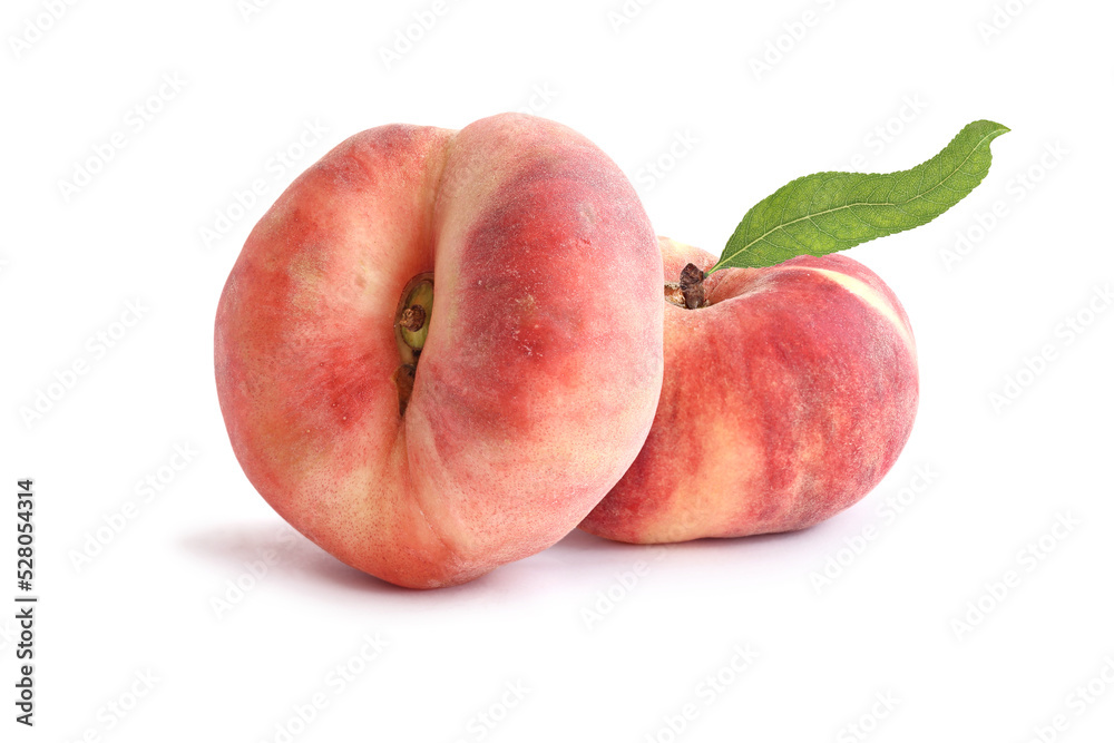 Two flat peaches with leaf isolated on white Two flat peaches with leaf isolated on white