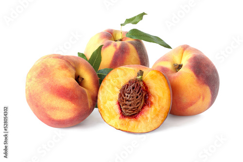 Three whole peaches and half with leaves isolated on white