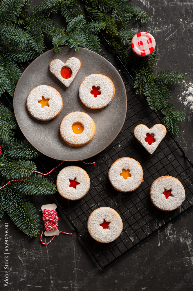 Linzer cookies served on a plate decorated with spruce branches Linzer cookies served on a plate decorated with spruce branches