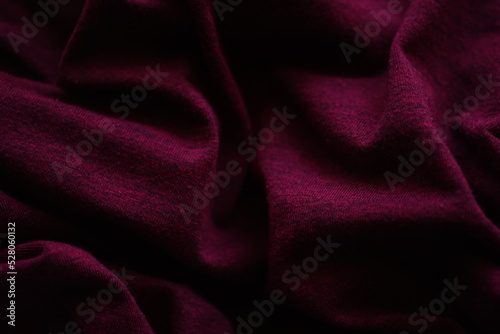 Closeup wrinkled bordo jersey, soft fabric background photo