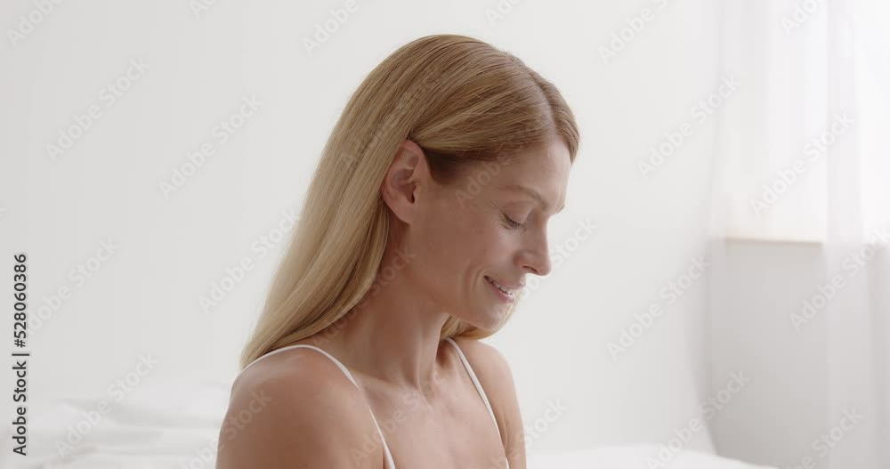 Portrait of beautiful senior woman in front of white bedroom background Portrait of beautiful senior woman in front of white bedroom background