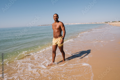 BOY WALKING ON THE BEACH ON A HAPPY VACATION