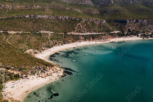 drone photo with sunny beach with people and a big blue ocean and clear sky. A perfect nature holiday day at the sea with boats © RABBPodructions