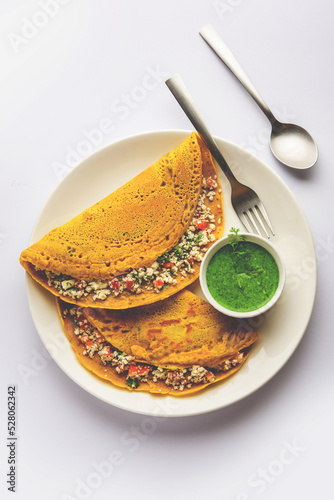 Paneer stuffed Besan chilla or Cheela made using chickpea flour with cottage cheese stuffing photo