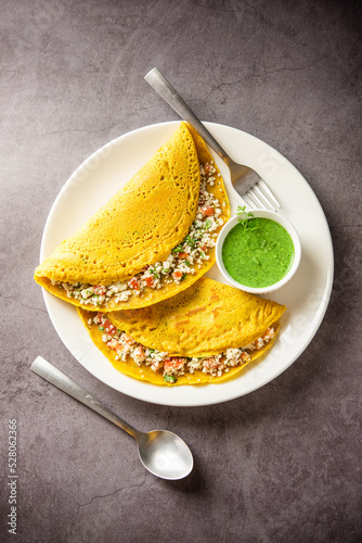 Paneer stuffed Besan chilla or Cheela made using chickpea flour with cottage cheese stuffing photo