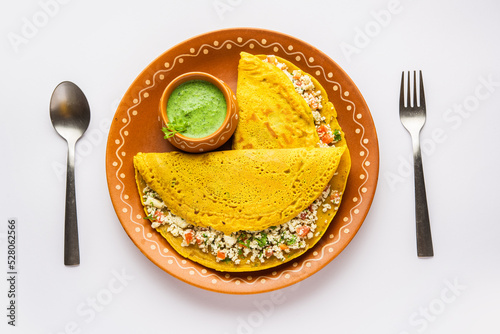 Paneer stuffed Besan chilla or Cheela made using chickpea flour with cottage cheese stuffing photo