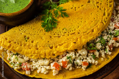 Paneer stuffed Besan chilla or Cheela made using chickpea flour with cottage cheese stuffing photo