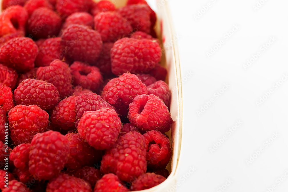raspberries in a bowl on white background raspberries in a bowl on white background