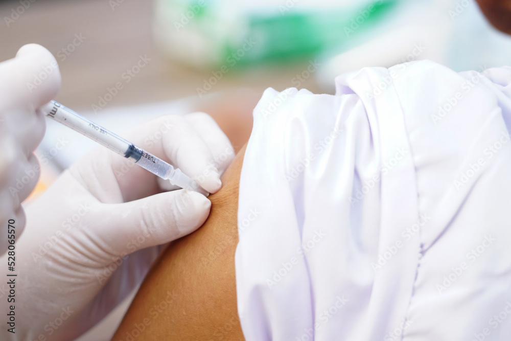 Nurse holding a syringe for the injection giving patient vaccine in hospital. Health care Concept Nurse holding a syringe for the injection giving patient vaccine in hospital. Health care Concept