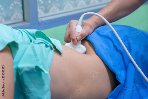 Closeup of man getting an ultrasound scan on abdominal by doctor