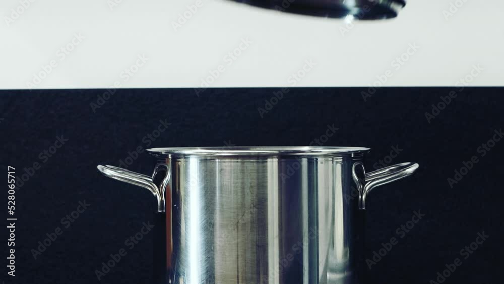 Passive Cooking pasta. Cover a pot you are cooking with with a lid. Steel pot comes covered for cooking on gas stove. Concept energy saving due to the natural gas crisis and global warming.