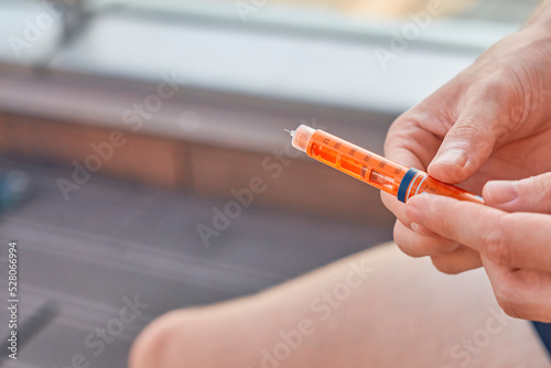 Type 1 Diabetes patient at a swim session with an insulin pen to inject dose syringe and correct the blood sugar for a healthy lifestyle without setbacks for a good healthcare. Medical equipment is ea photo