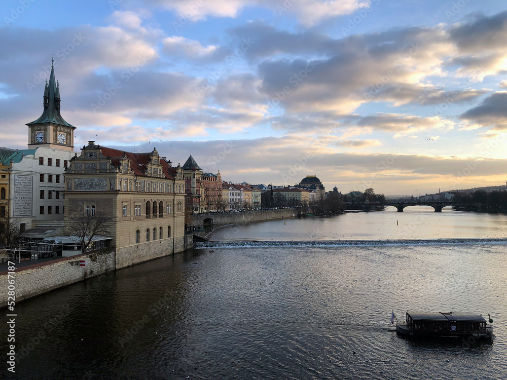 Sunset in Prague. Panoramic view with Vltava river, colorful sky and old Czech buildings. Best Czech scenery, most beautiful Prague photos