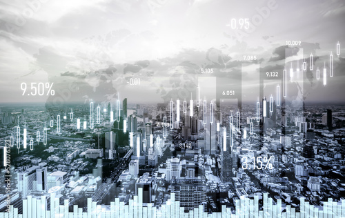 Financial graphs and digital indicators overlap with modernistic urban area, skyscrabber for stock market business concept. Double exposure.