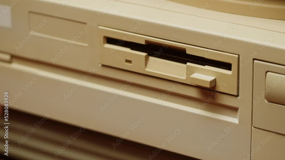 Using diskette for old computer. Music recorder, playing retro computer games. Vintage device for office, obsolete technology. Using diskette for old computer. Music recorder, playing retro computer games. Vintage device for office, obsolete technology.