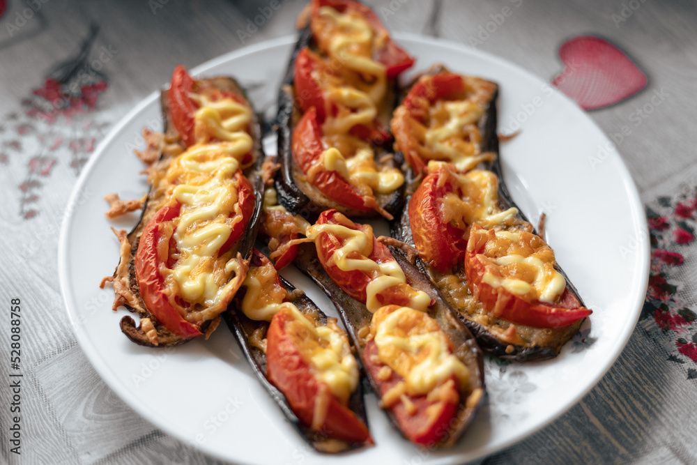 Fried eggplant with tomatoes and cheese. Georgian eggplant