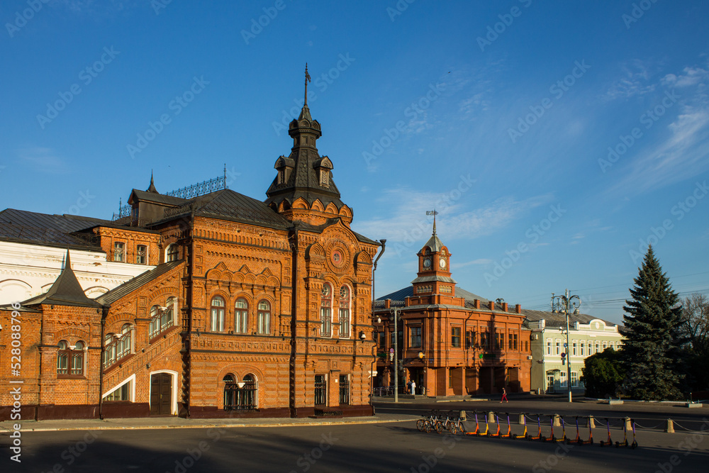 Fototapeta premium VLADIMIR, RUSSIA - AUGUST, 17, 2022: the historic brick facade of the Friendship House and the City Duma building in the old town on a sunny summer day and copy space