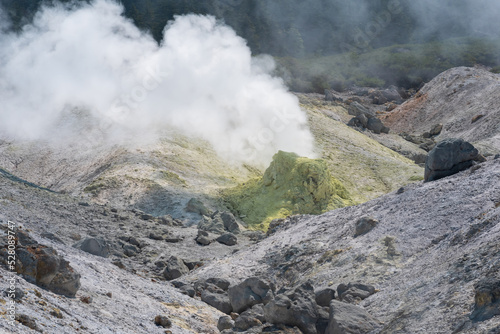 tower of crystallized sulfur around a solfatara in the fumarole field on the slope of a volcano