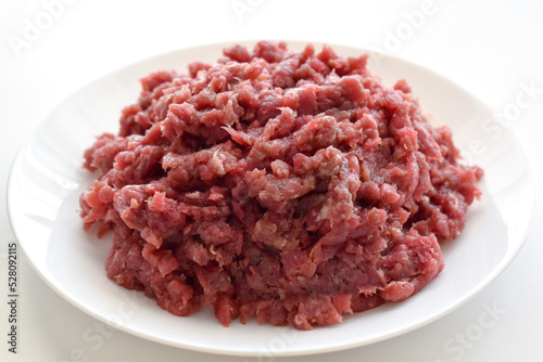 Raw minced beef or ground beef on a white plate.
