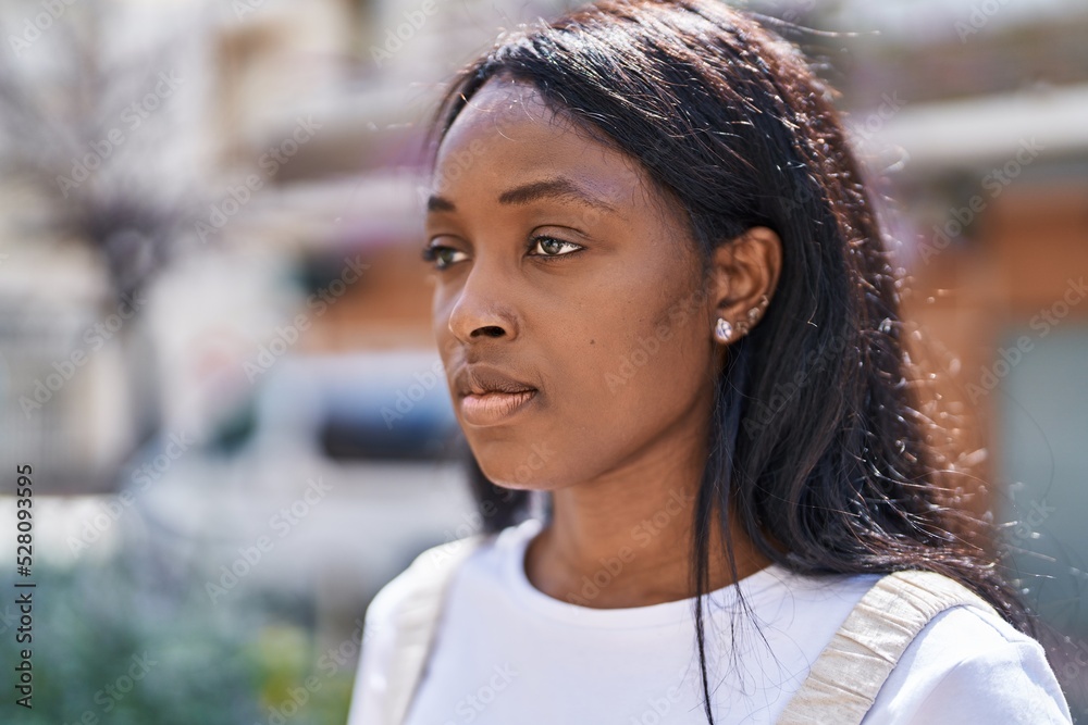 Young african american woman wearing glasses with relaxed expression at street