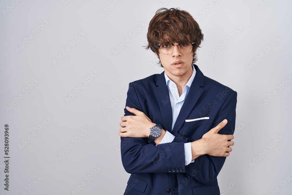 Hispanic business young man wearing glasses shaking and freezing for winter cold with sad and shock expression on face Hispanic business young man wearing glasses shaking and freezing for winter cold with sad and shock expression on face