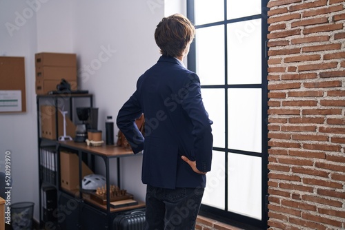 Wallpaper Mural Young blond man business worker looking throw the window at office Torontodigital.ca