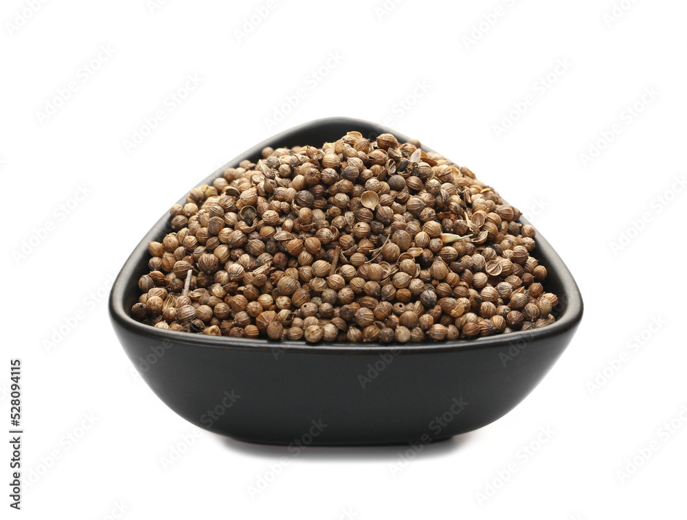 Pile coriander seeds in porcelain bowl isolated on white Pile coriander seeds in porcelain bowl isolated on white