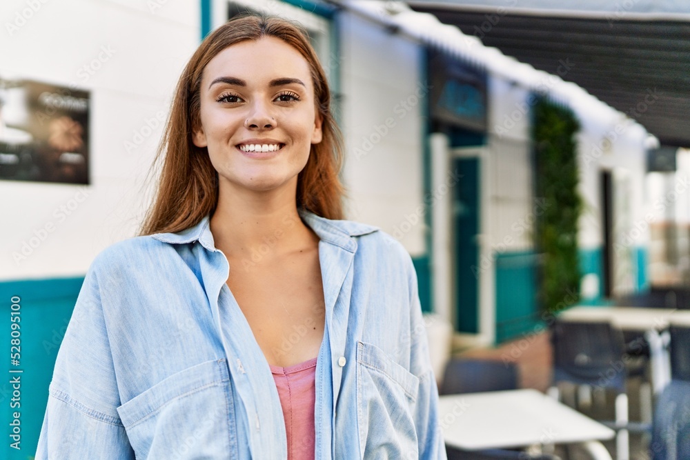 Fototapeta premium Young hispanic girl smiling happy standing at the city.