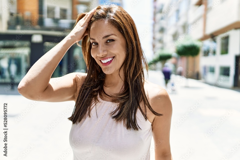 Hispanic beautiful woman standing outdoors smiling happy on a sunny day
