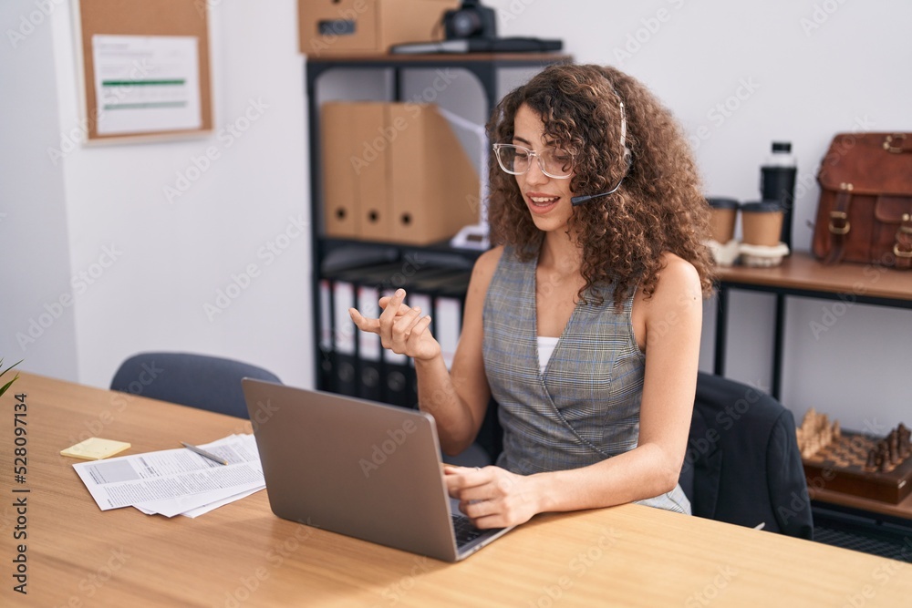Young beautiful hispanic woman call center agent having video call at office Young beautiful hispanic woman call center agent having video call at office