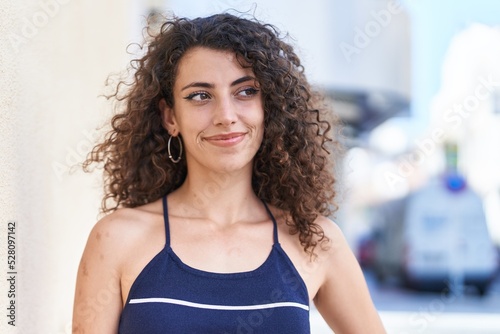 Young beautiful hispanic woman smiling confident looking to the side at street Free Download Young beautiful hispanic woman smiling confident looking to the side at street - GFXLoad