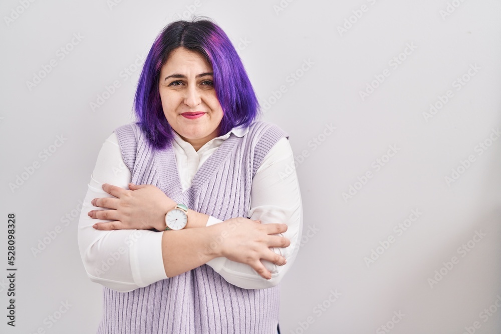 Plus size woman wit purple hair standing over white background shaking and freezing for winter cold with sad and shock expression on face