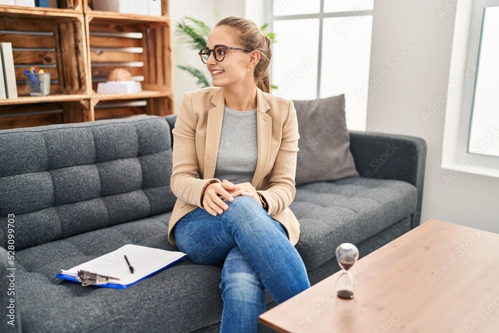 Young woman working at consultation office looking away to side with smile on face, natural expression. laughing confident. Young woman working at consultation office looking away to side with smile on face, natural expression. laughing confident.