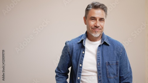 Portrait of happy casual older man smiling, Mid adult, mature age guy with gray hair, Isolated on white background, copy space.