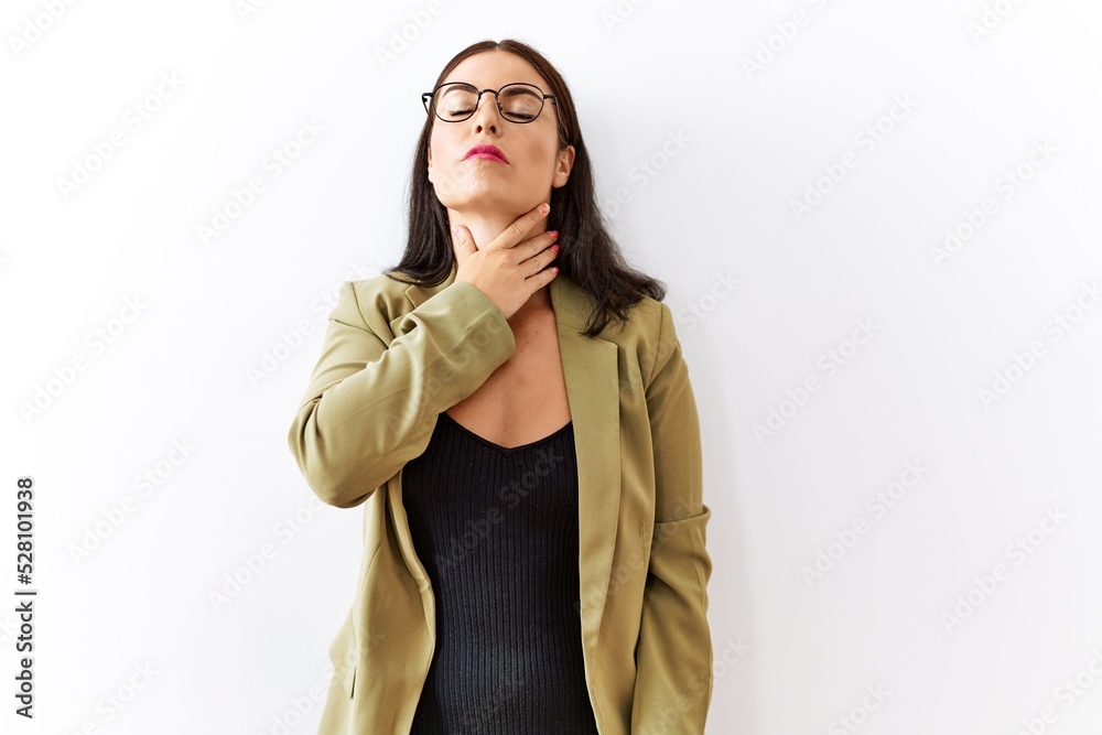 Young brunette woman standing over isolated background touching painful neck, sore throat for flu, clod and infection Young brunette woman standing over isolated background touching painful neck, sore throat for flu, clod and infection