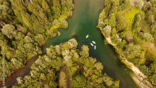 Two rivers coming together, some rafting boats.
