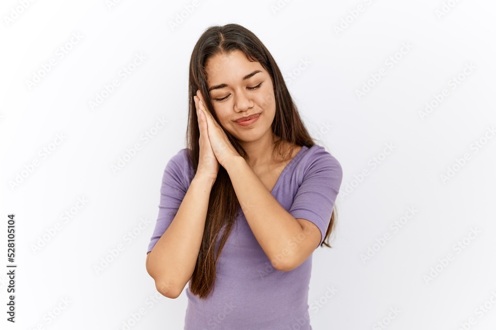 Young brunette woman standing by isolated background sleeping tired dreaming and posing with hands together while smiling with closed eyes. Young brunette woman standing by isolated background sleeping tired dreaming and posing with hands together while smiling with closed eyes.