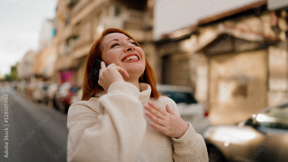 Young redhead woman smiling confident talking on the smartphone at street Young redhead woman smiling confident talking on the smartphone at street