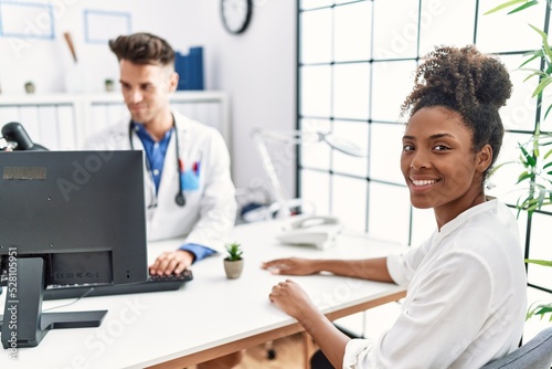 Man and woman wearing doctor uniform having medical consultation at clinic