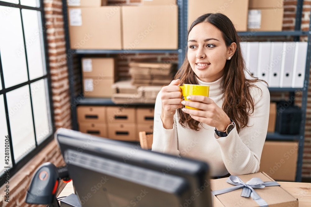 Young beautiful hispanic woman ecommerce business worker drinking coffee at office Young beautiful hispanic woman ecommerce business worker drinking coffee at office