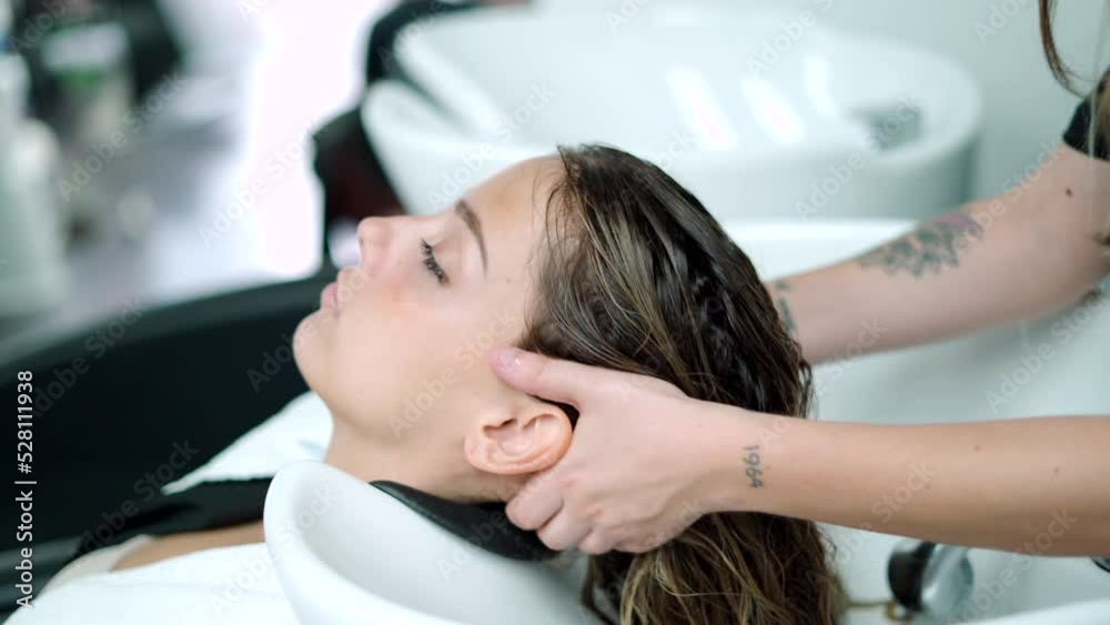 Hairstylist Washing Hair Of Client Over Sink Hairstylist Washing Hair Of Client Over Sink