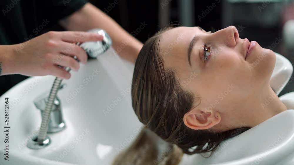 Woman In The Beauty Salon While Having Her Hair Washed Woman In The Beauty Salon While Having Her Hair Washed