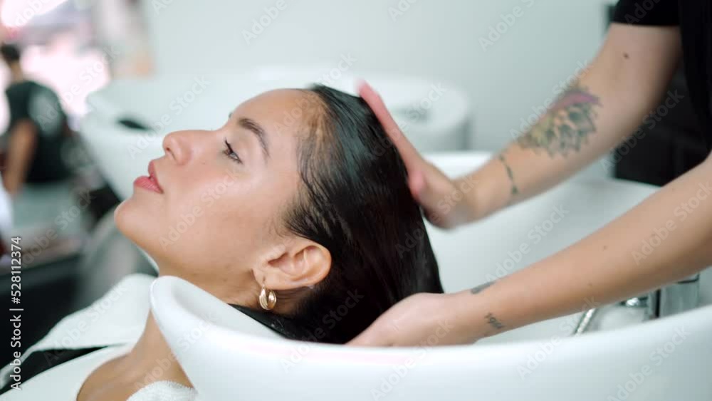 Caucasian woman getting her hair washed Caucasian woman getting her hair washed