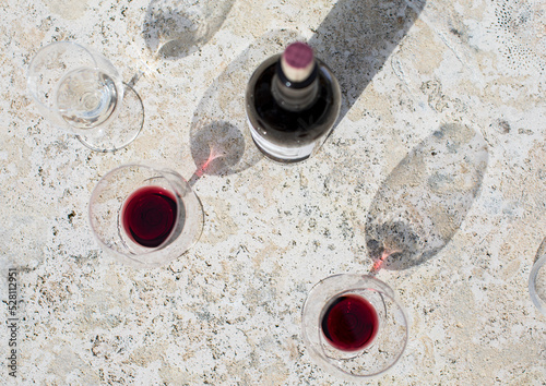 Wine bottle and red wine glasses shot from above